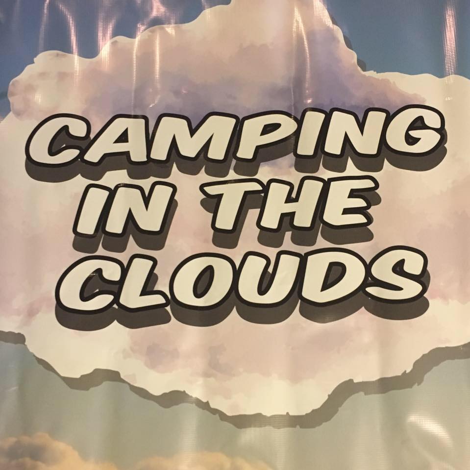 Text on an image reads "Camping in the Clouds" against a cloudy sky background.